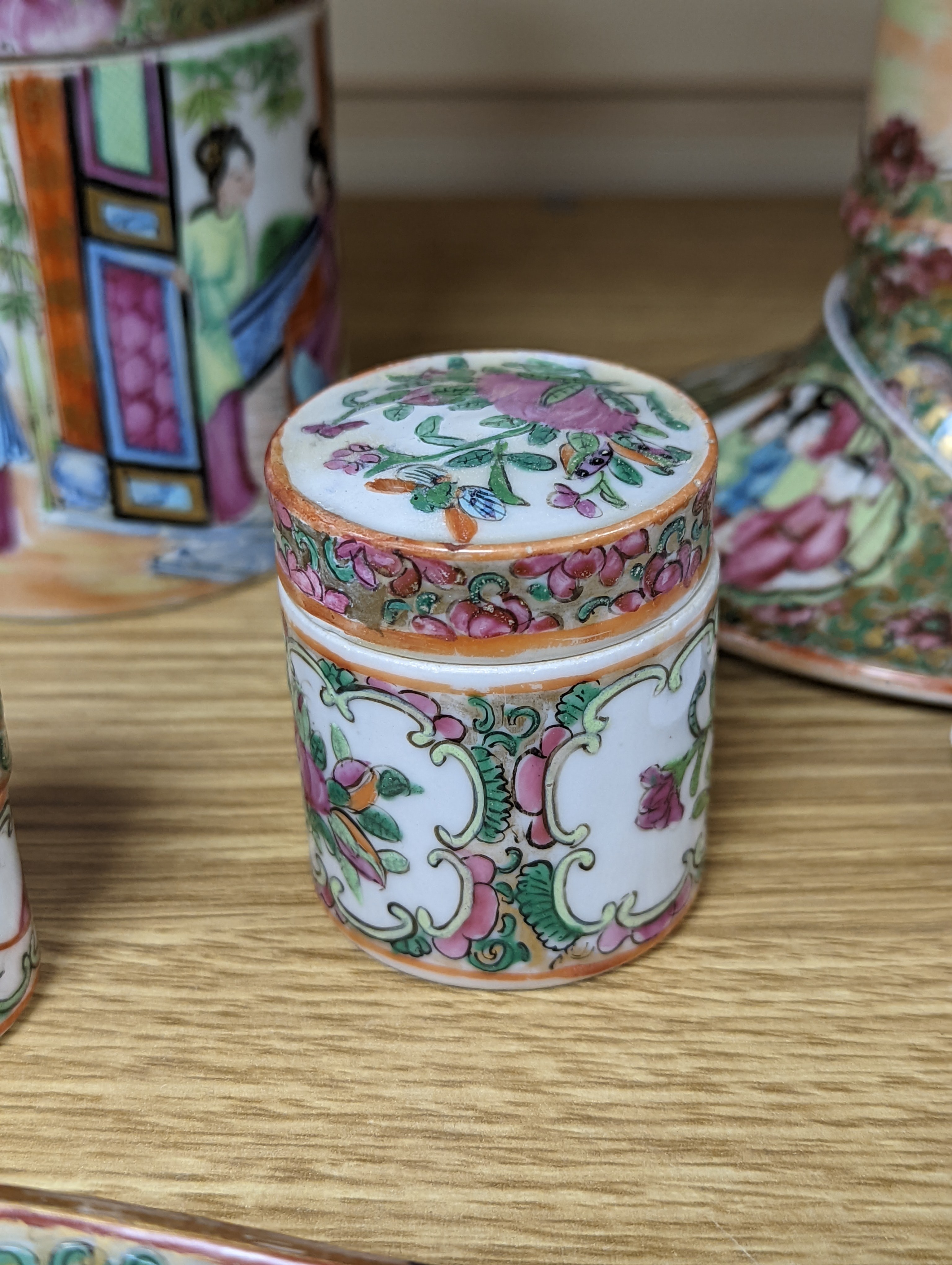 A Chinese Canton famille rose nest of boxes and covers, a similar candlestick and a tray 23cm